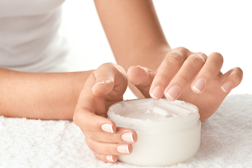 Woman applying cream isolated on white background