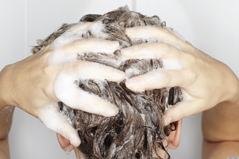 Woman washing her hair in shower